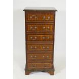 An inlaid mahogany chest of six drawers, with brass swan neck handles, raised on bracket supports,