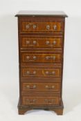 An inlaid mahogany chest of six drawers, with brass swan neck handles, raised on bracket supports,