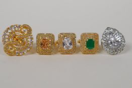 Four Indian gilt metal dress rings set with semi precious stones, and a similar silvered metal dress