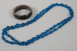 An agate bangle and a blue glass bead necklace, 32" long