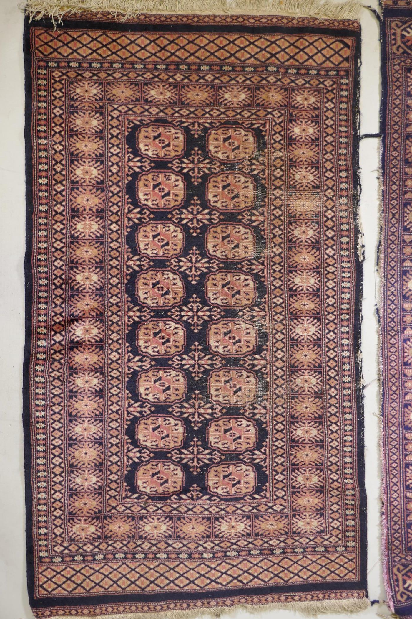 A Turkish blue ground Bokhara rug, a similar black ground Bokhara rug and two others, largest 68" - Image 9 of 12