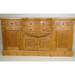 A pine mirror backed sideboard, with carved decoration, the bow fronted base with four drawers