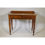 A Victorian mahogany two drawer writing table on turned supports, 35½"  x 17", 31" high