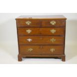 A George III mahogany chest of two over three drawers with cockbeaded detail and original pierced