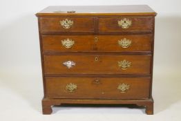 A George III mahogany chest of two over three drawers with cockbeaded detail and original pierced