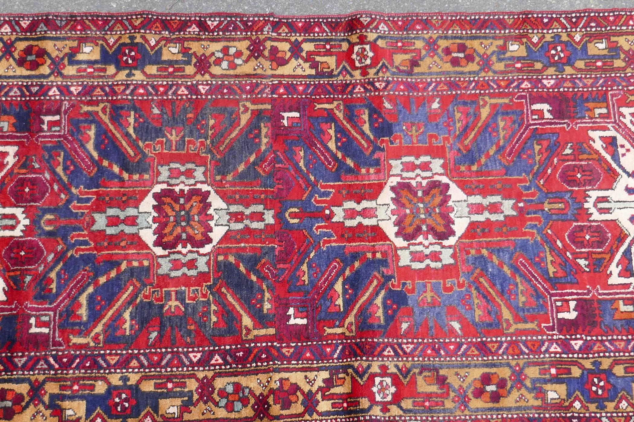 A Persian red ground Heritz runner with a starburst medallion design, 46" x 131" - Image 2 of 8