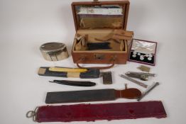 A vintage vanity box containing cut throat razors, collar studs, retracting pencils, smoking