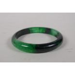 A Chinese bi-colour green hardstone bangle, 3" diameter