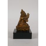 A Sino Tibetan gilt bronze figure of Buddha, on a display stand, 3" high