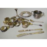 Quantity of hallmarked silver including napkin rings, cigar holder, various spoons, sovereign holder