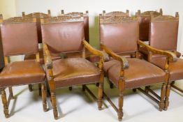 A set of eight (6+2) oak and leather dining chairs with carved details and scrolled arms