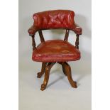 A Victorian mahogany swivel desk chair with buttoned leather upholstery