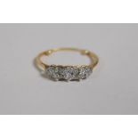 An antique 18ct yellow gold five stone diamond ring, one stone replaced with glass, the ring with