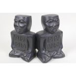 A pair of Irish Celtic head bookends carved from compressed ancient turf, 7" high