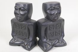 A pair of Irish Celtic head bookends carved from compressed ancient turf, 7" high