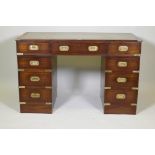 A mahogany veneered campaign pedestal desk with nine drawers and a leather inset top, 48" x 24", 30"