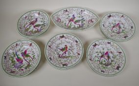 A Continental porcelain part dessert service comprising oval serving dish, four 8" bowls and nine