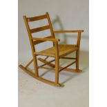 A pine rocking chair with sea grass seat possibly Scandinavian, mid C20th