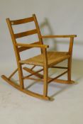 A pine rocking chair with sea grass seat possibly Scandinavian, mid C20th