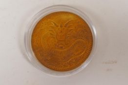 A Chinese gilt metal coin, 2" diameter