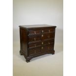 An C18th oak chest of two over three drawers, with moulded fronts and brass drop handles, panelled