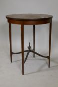 An Edwardian mahogany circular top table, with painted decoration, raised on tapering supports