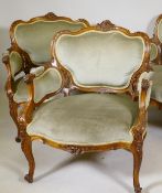 A pair of C19th walnut armchairs wit carved and pierced backs, en suite to previous lot