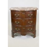 An antique mahogany veneered commode, with marble top and shaped front and three drawers with ormolu