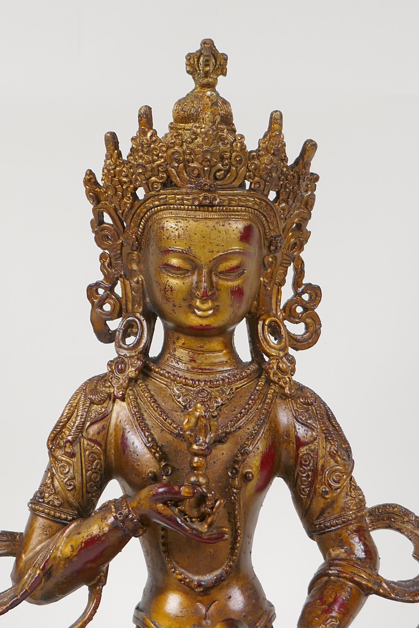 A Sino Tibetan gilt bronze of Buddha carrying two vajra, 12" high - Image 2 of 4