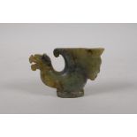 A Chinese mottled green jade rhyton with carved mask and kylin decoration, 4" long