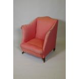 A Victorian upholstered parlour armchair on swept square supports