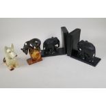 A pair of ebony elephant bookends, a Russian porcelain figure of a bear and a pottery terrier, 6½