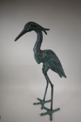 A patinated garden figure of a heron, 27½" high