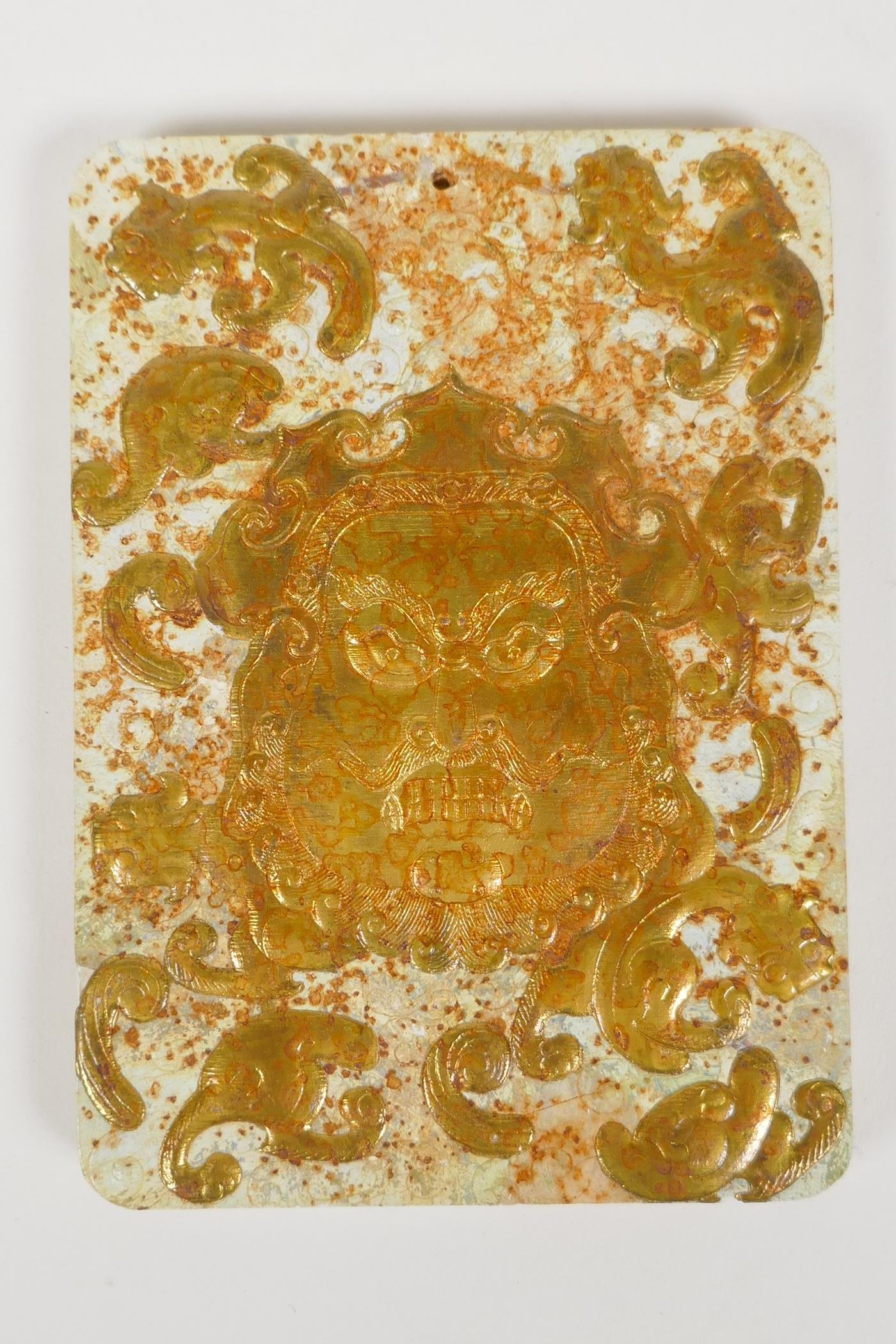 A Chinese hardstone tablet with carved and gilt mask and kylin decoration, 3½" x 4½"