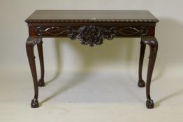 A mahogany centre table, the top with gadrooned edge, the frieze with all round carved decoration,