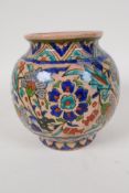 A Palestine pottery bulbous vase painted with flowers, 5½" high