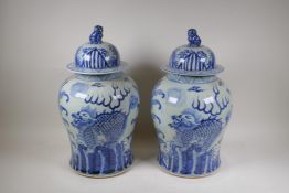 A pair of Chinese blue and white porcelain storage jars with kylin decoration and fo dog knops,