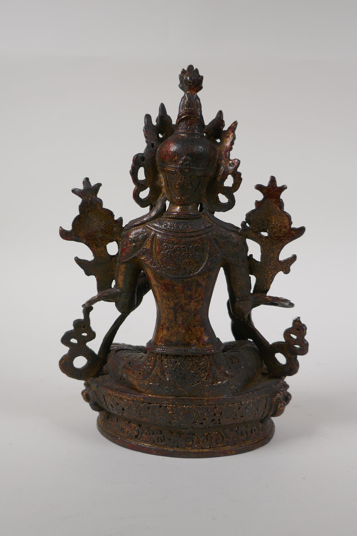 A Sino Tibetan bronze figure of Buddha seated on a lotus throne, with the remnants of gilt patina, - Image 4 of 6