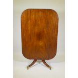 A Regency mahogany tilt top breakfast table, raised on a turned column and splay supports, 37" x 53"