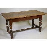 An antique oak refectory table, the plank top with cleated ends and sides, raised on barley twist