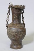 A Chinese bronze vessel with cover and raised archaic style decoration, 10" high