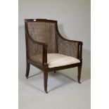 A C19th mahogany bergere armchair with ebony inlaid stringing, raise on square tapering supports