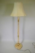 A painted turned wood column standard lamp decorated with roses, with a good silk shade, 71" high