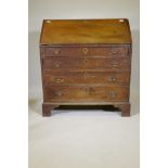 A Georgian oak fall front bureau, with fitted interior  over four long drawers, raised on bracket