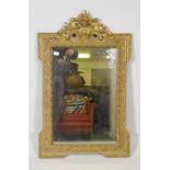 A late C19th French giltwood and composition wall mirror with pierced crest and original mirror