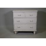 A C19th white painted pine chest of drawers, two short over two long, raised on turned supports,