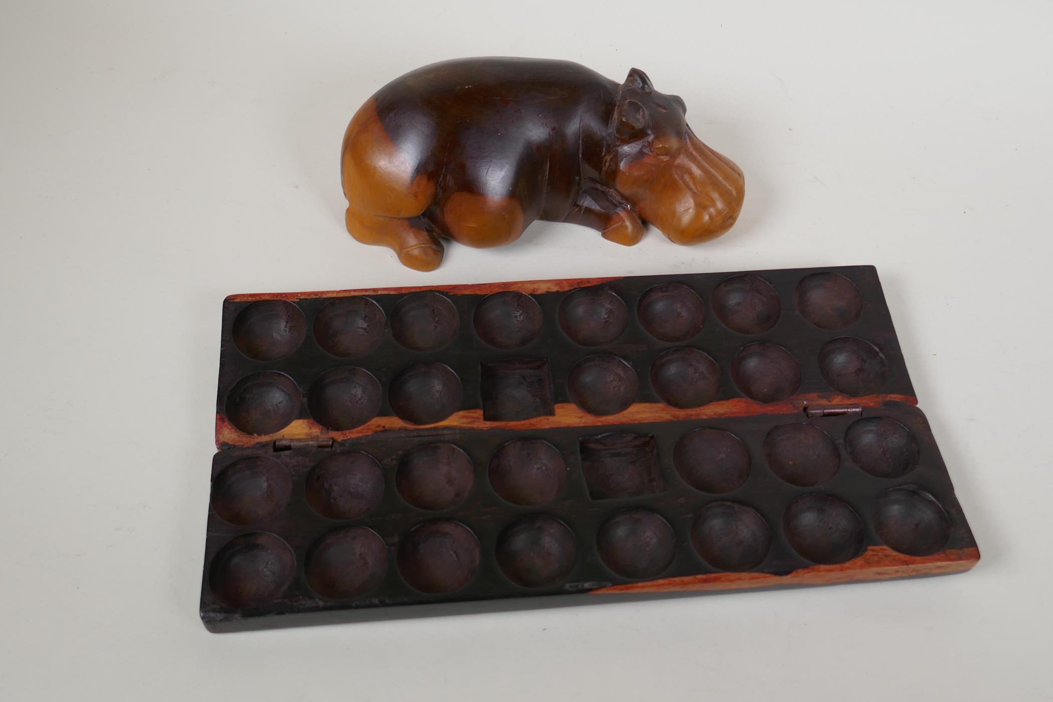 An African hardwood Bao Mancala board carved with rhinos, 13" long, and an African carved hardwood - Image 4 of 5