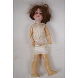 An Armand Marseille bisque doll No 390 with four teeth and closing eyes, and jointed composition