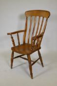 A Windsor bar back arm chair with elm seat, 43" high