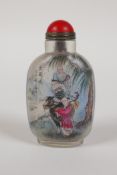 A Chinese reverse decorated  glass snuff bottle depicting travellers on an ox and a riverside